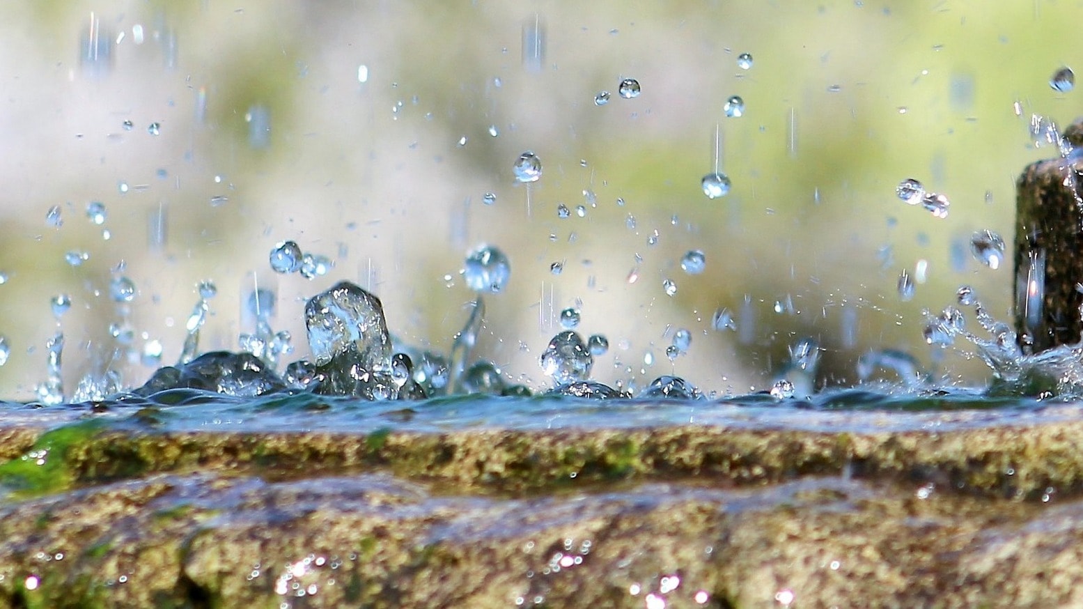 Wassertropfen spritzen auf einem Brunnen