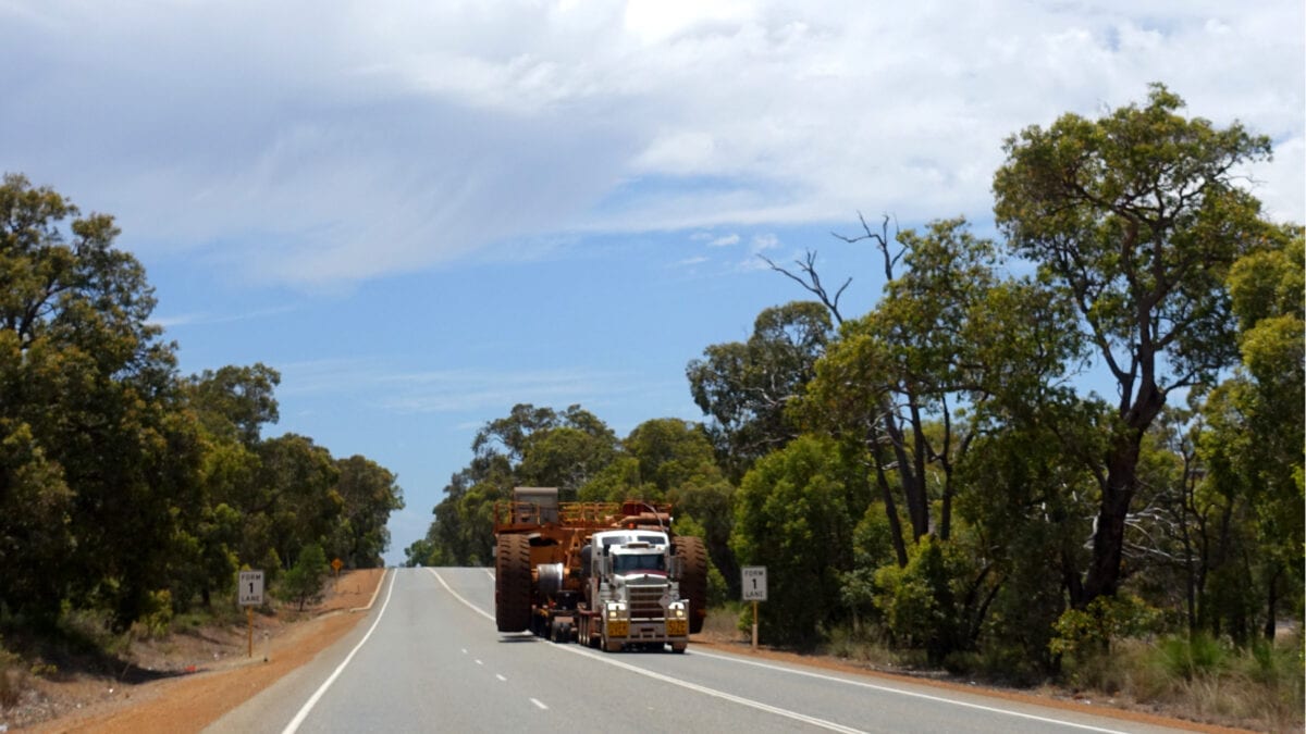 Ein riesiger Truck auf einer Straße mitten im Outback